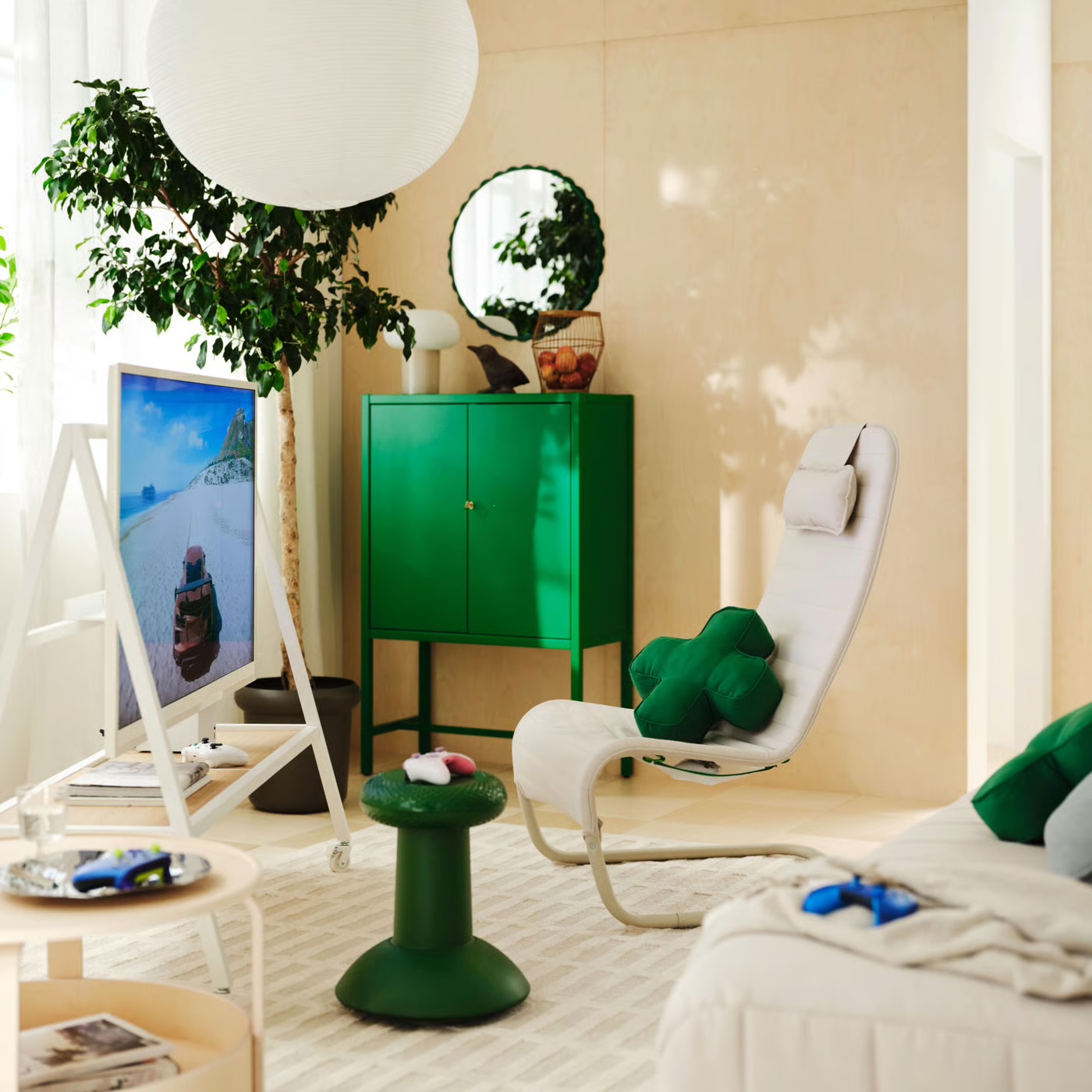 The YXSTABY collection in a living room: TV stand, lounge chair with D-pad cushion, green thumbstick stool and side table